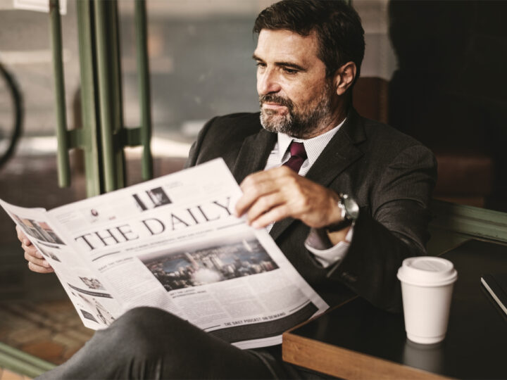 Politician reading news on sofa