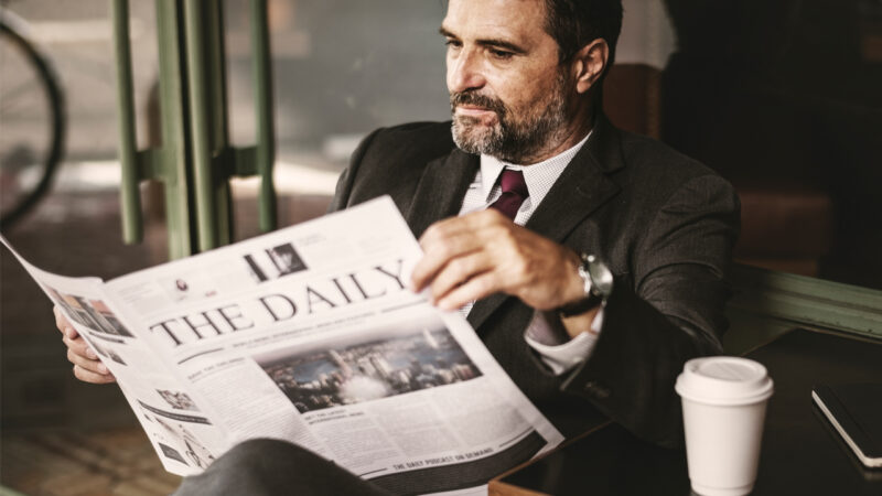 Politician reading news on sofa