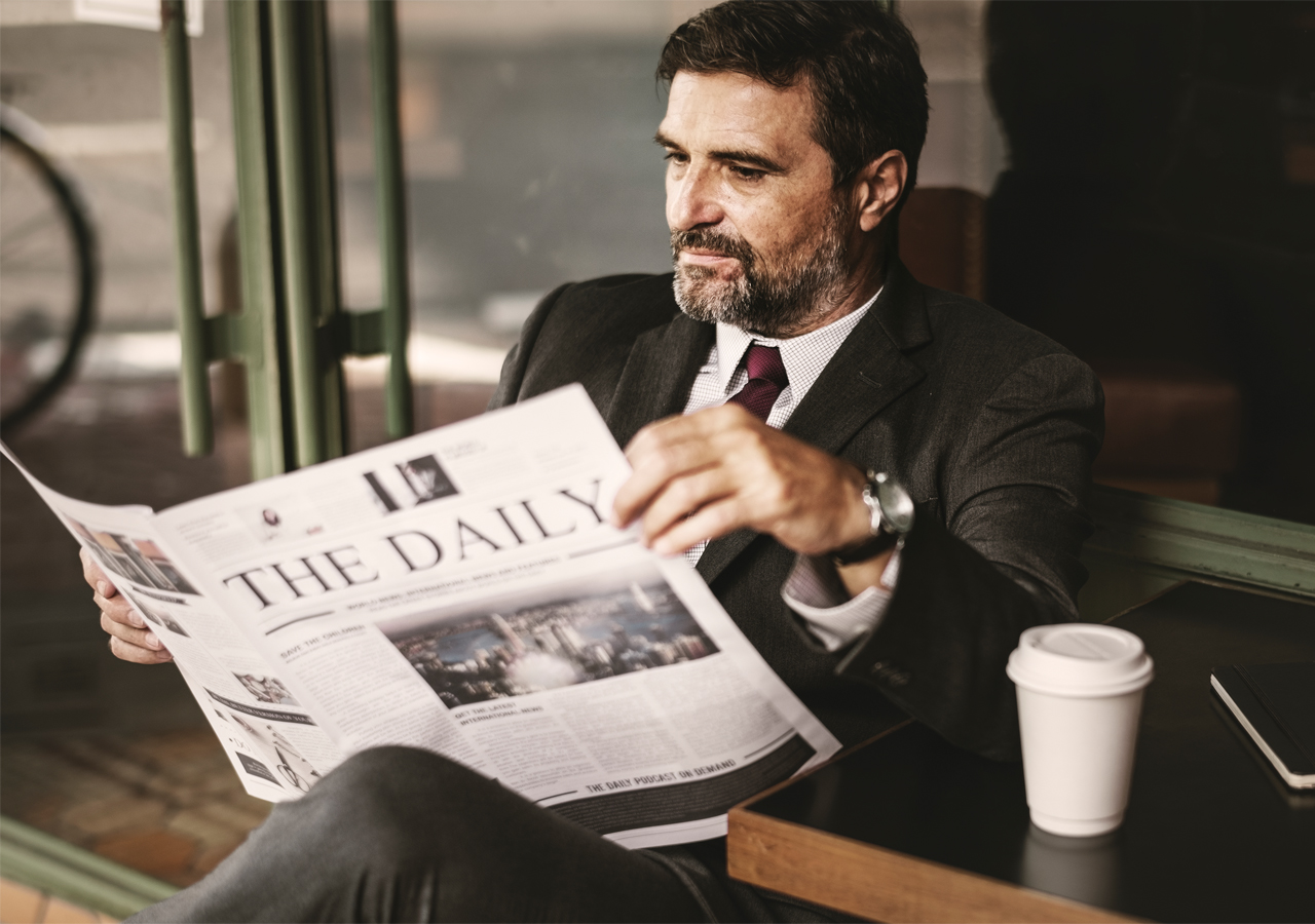 Politician reading news on sofa